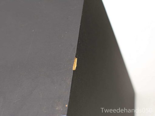 Sleek black triangular decor highlighting modern design and unique imperfections.