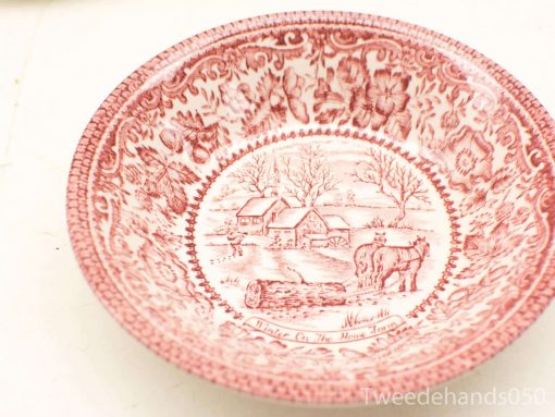 Vintage ceramic bowl featuring a winter landscape and floral patterns in vibrant red transferware.