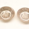 Vintage decorative ceramic dishes featuring a serene landscape and floral designs. Perfect for collectors.