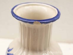 Elegant ceramic vase with cobalt blue rim and floral design, showcasing unique craftsmanship.