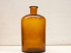 Vintage amber glass apothecary bottle with unique bubbles, perfect for decor or collection.