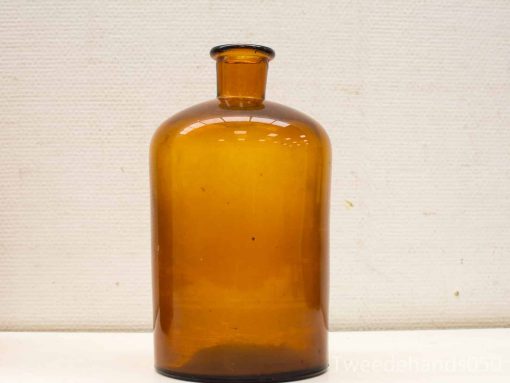 Vintage amber glass apothecary bottle with unique bubbles, perfect for decor or collection.