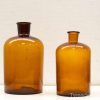 Vintage amber glass bottles set of two, perfect for decor or storage, exuding timeless elegance.