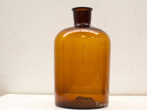 Vintage amber apothecary bottle with handcrafted details, perfect for decor and storage.