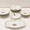 Elegant porcelain dinnerware set with historical motifs for special occasions and decorative display.