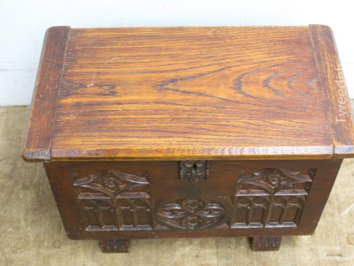 Ornate antique wooden chest with intricate carvings and rich wood grain, perfect for decor.
