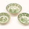 Vintage green transferware bowls featuring intricate scenic and floral motifs, perfect for decor or collection.