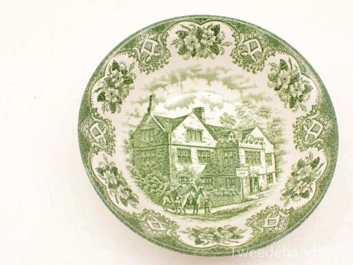 Vintage green decorative plate featuring an inn and floral designs, perfect for collection or decor.