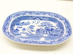 Elegant blue and white porcelain platter featuring a serene Asian landscape design.