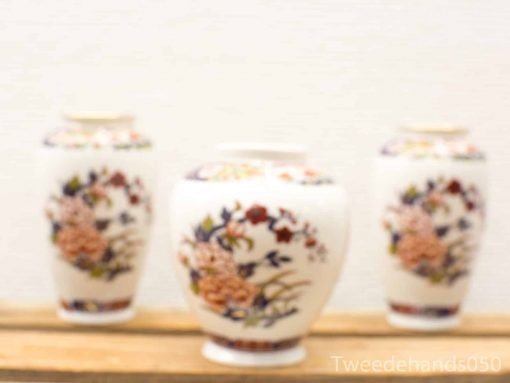 Elegant vintage vases with vibrant floral patterns, perfect for enhancing any interior decor.