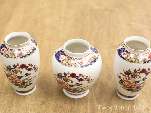 Elegant vintage porcelain vases featuring intricate floral patterns, perfect for decor or functional art.