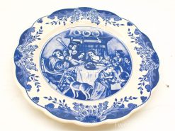 Charming decorative plate featuring a festive family gathering in traditional attire.