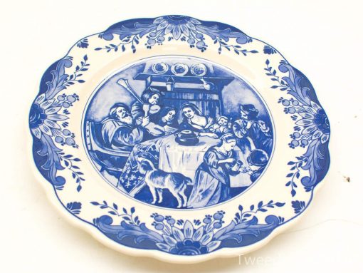 Charming decorative plate featuring a festive family gathering in traditional attire.