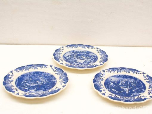 Elegant set of three vintage blue and white decorative plates showcasing intricate transferware designs.