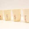 Charming vintage beige mugs with floral design, perfect for cozy gatherings and warm memories.