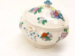 Floral porcelain bowl with lid, vibrant colors, artisanal craftsmanship, decorative and functional piece.
