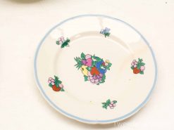 Charming vintage hand-painted plate featuring vibrant flowers and fruits, perfect for decor or serving.