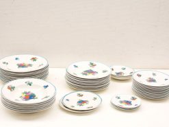 Elegant vintage ceramic plates featuring vibrant floral designs, perfect for dining and decor.