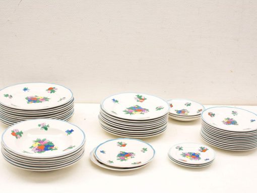 Elegant vintage ceramic plates featuring vibrant floral designs, perfect for dining and decor.