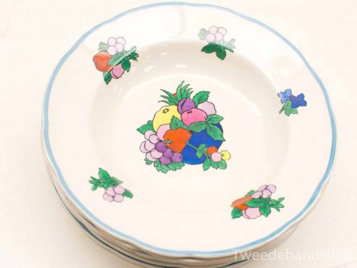 Colorful ceramic plates adorned with vibrant fruit and floral designs for elegant dining occasions.
