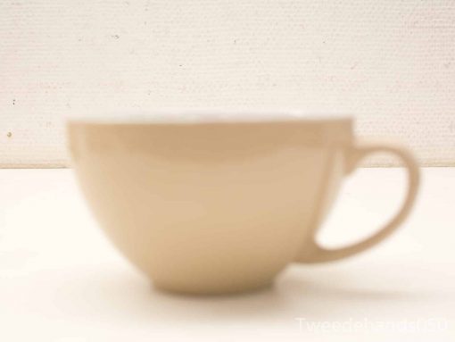 Simple ceramic cup in soft beige, perfect for enjoying your favorite hot beverages.