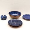 Charming blue and brown ceramic dinnerware set with playful white dots, perfect for any occasion.