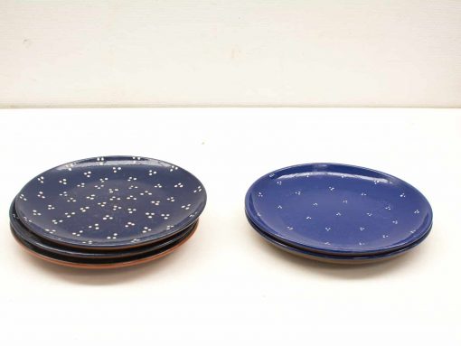 Vibrant blue ceramic plates with unique patterns, perfect for casual or formal dining experiences.