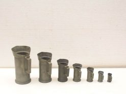 Vintage metal funnels in various sizes, ideal for kitchen and workshop use.