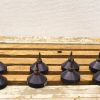 Set of 8 vintage metallic tops on rustic wooden table, perfect for collectors and decor.
