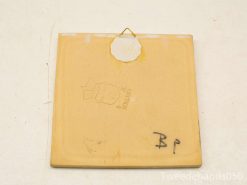 Vintage yellow ceramic tile with HOLLAND mark, perfect for wall decoration and collectors.