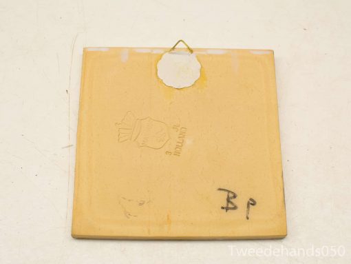Vintage yellow ceramic tile with HOLLAND mark, perfect for wall decoration and collectors.