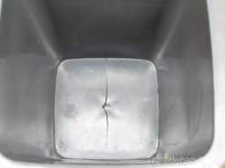 Damaged grey storage container with a glossy finish and practical rectangular design.