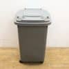 Durable gray trash bin with wheels for easy moving, perfect for home and commercial use.
