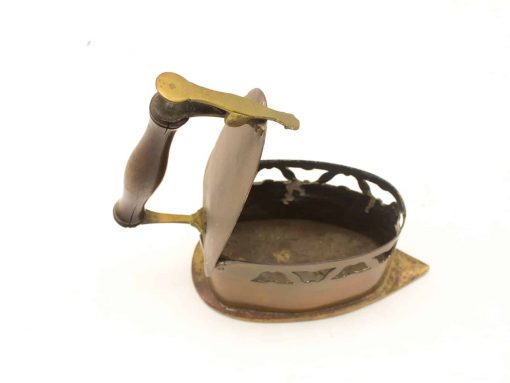 Vintage iron with wooden handle showcasing unique patina and historical craftsmanship.