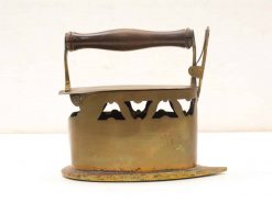 Antique brass iron with wooden handle, showcasing vintage craftsmanship and timeless charm.