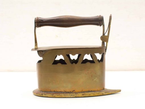 Antique brass iron with wooden handle, showcasing vintage craftsmanship and timeless charm.