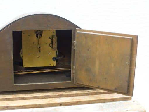 Antique wooden clock with brass mechanism, showcasing exquisite craftsmanship and nostalgic charm.