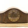 Elegant vintage mantel clock in dark wood with gold accents for timeless home decor.