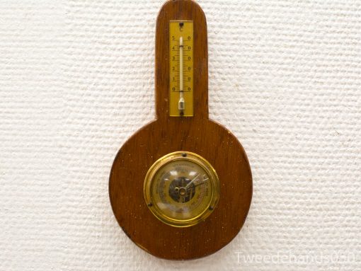Antique wooden barometer and thermometer with vintage charm and elegant craftsmanship.