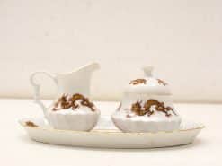 Elegant porcelain creamer and sugar bowl set with intricate dragon design for refined dining.