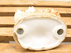 Antique ceramic figurine in earthy tones, showcasing vintage charm and exquisite craftsmanship.