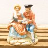 Charming porcelain figurine of a romantic couple, perfect for collectors and decor.