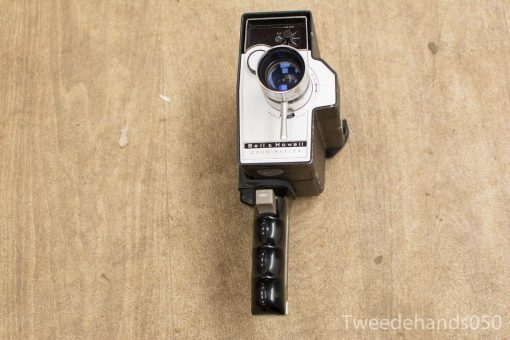 Vintage Bell & Howell film camera with sleek design and blue-tinted lens.