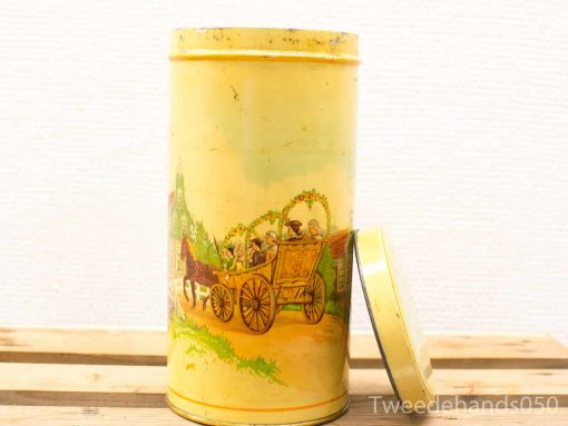 Vintage yellow tin featuring a horse-drawn carriage illustration, perfect for collections or decor.