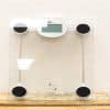 Sleek modern glass and metal digital bathroom scale with easy-to-read display and stability features.