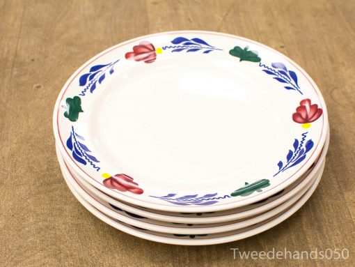 Elegant floral-patterned plates on rustic wood, perfect for stylish dining occasions.