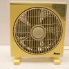 Retro yellow Fermi table fan with square design for optimal airflow and nostalgic charm.