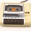 Vintage 1980s Commodore cassette tape player with original buttons and nostalgic design.