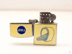 Vintage chrome lighter with yellow TRIP logo and artistic tunnel design. Perfect for collectors.