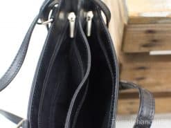 Stylish black leather handbag with zipper compartments for elegance and practicality. Perfect for everyday use.